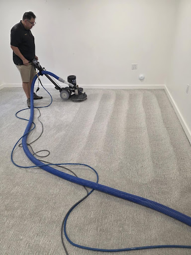 Jimmy, owner of Vital Clean, operating a professional carpet cleaning machine